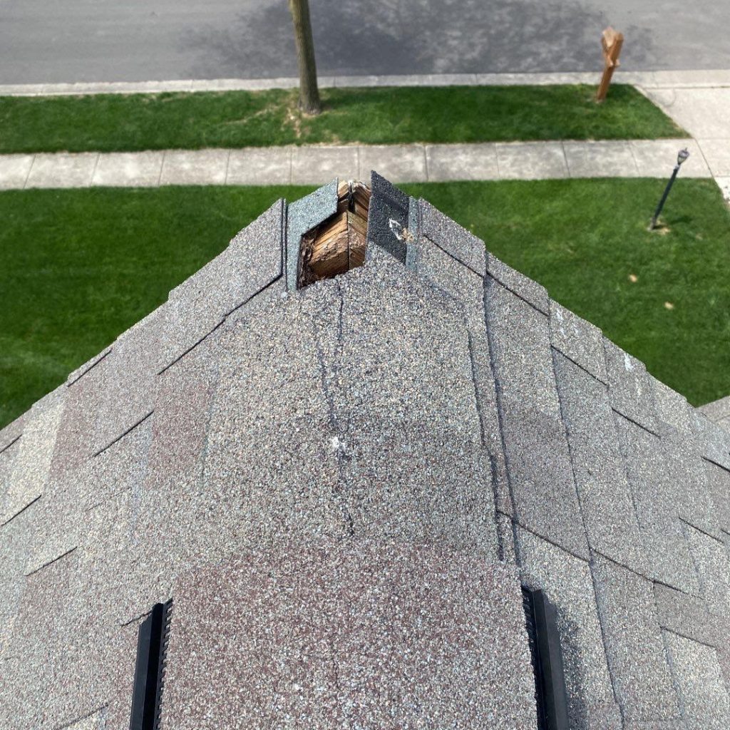 The image shows icicles hanging from the roof of a house alongside text about winter roof maintenance myths and facts in Columbus.